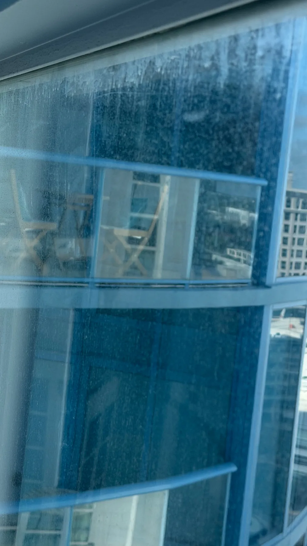 Residue visible on residential glass before professional window cleaning