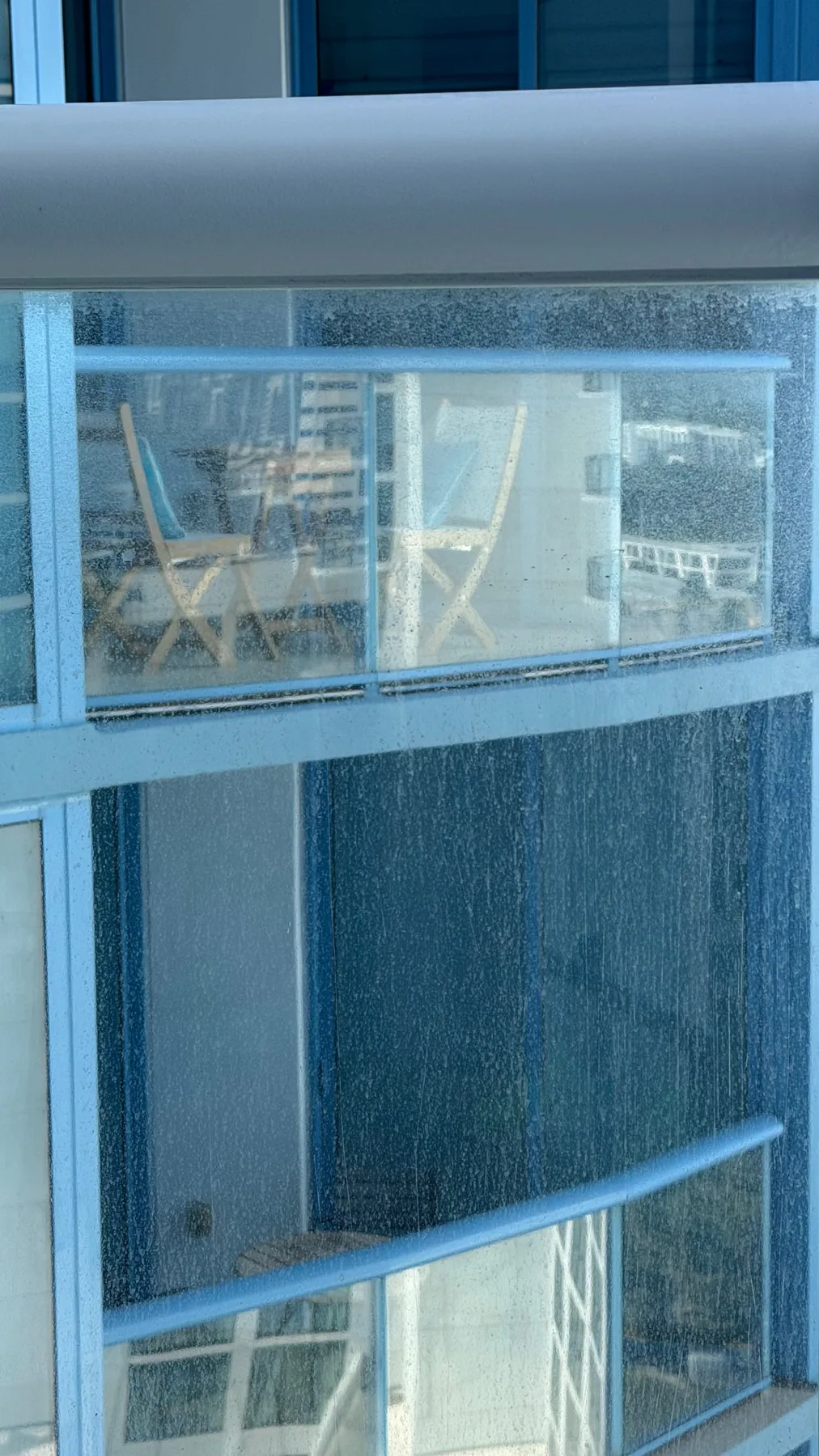Balcony glass railing before professional cleaning in Las Olas