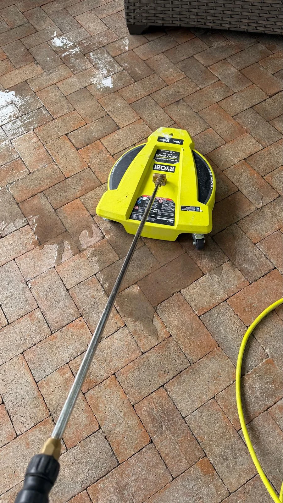 Professional surface cleaner positioned on residential pavers