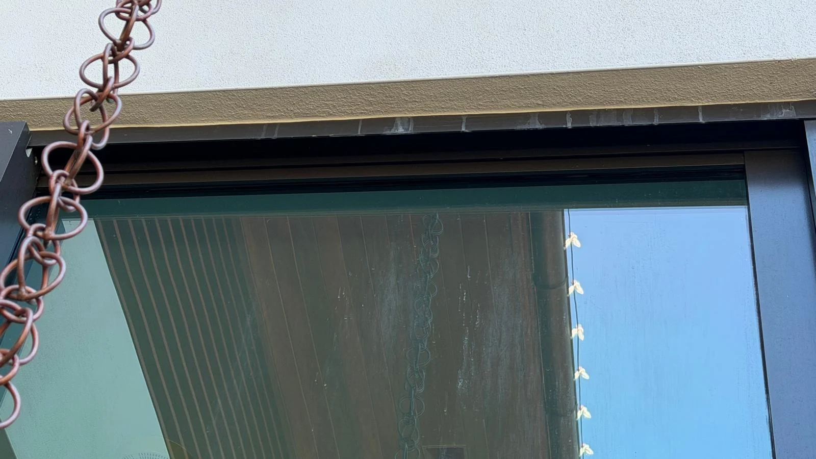 Exterior residential window and overhang before window cleaning